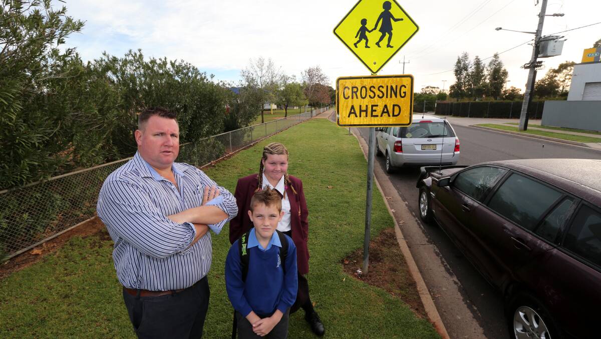 GRAVE FEARS: Griffith councillor Doug Curran, with children Jackson, 10, and Emily, 13, is worried about motorists not obeying rules at school drop-off points.