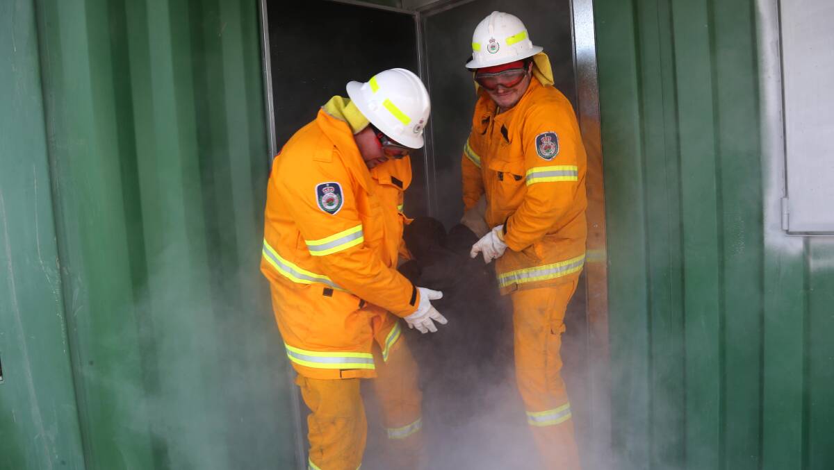 Joel Hanwood and John Grigg rescue Ryan O'Meara in a training session for the NSW Rural Fire Service in Griffith.
