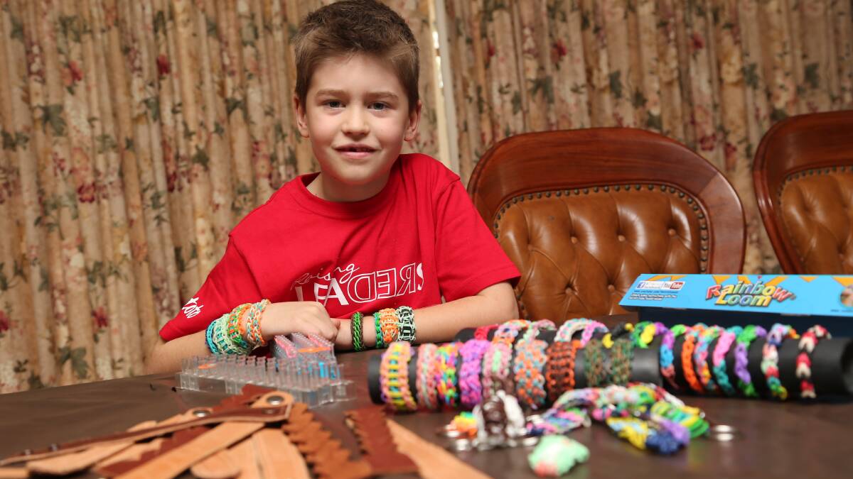 BANDS OF HOPE: Jack Villa, 7, with the loom bands and other items he is making to sell to raise funds for orphans in Africa.