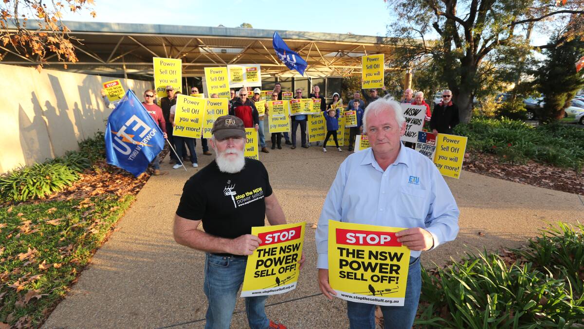 PEOPLE POWER: Griffith resident Steve McLean and Mick Hoppie, from the Electrical Trades Union of Australia NSW branch, join around 50 locals rallying outside Adrian Piccoli's office.