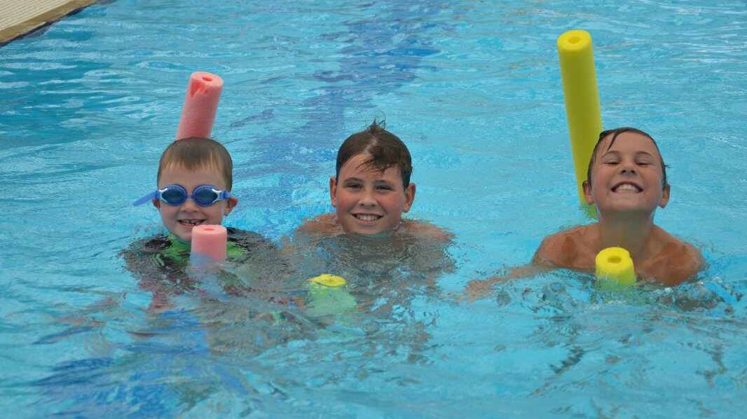Isaac Gooden, 6, Zyon Shepherd, 12 and Brandon Shepherd, 9, cool off in Junee. Picture: Declan Rurenga