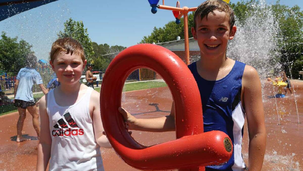Mason Truscott, 9, and Angus Bartter, 10, at City Park in Griffith. Picture: Anthony Stipo