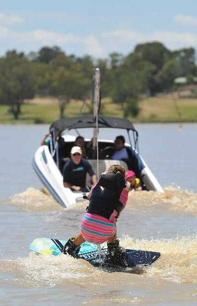 Chloe Lenehan, 11, has a crack at wakeboarding at a day for kids to try out water activities on Lake Albert, hosted by Lake Albert Boat Club. Picture: Addison Hamilton