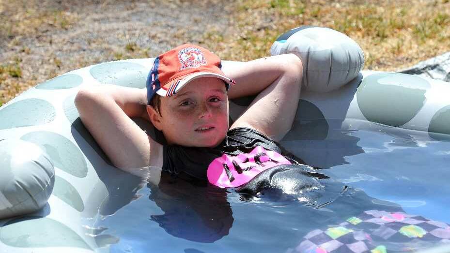 Logan Hotston, 8, of the IGA Jock and G Strings cools down between games at the Cootamundra Touch Carnival. Picture: Michael Frogley