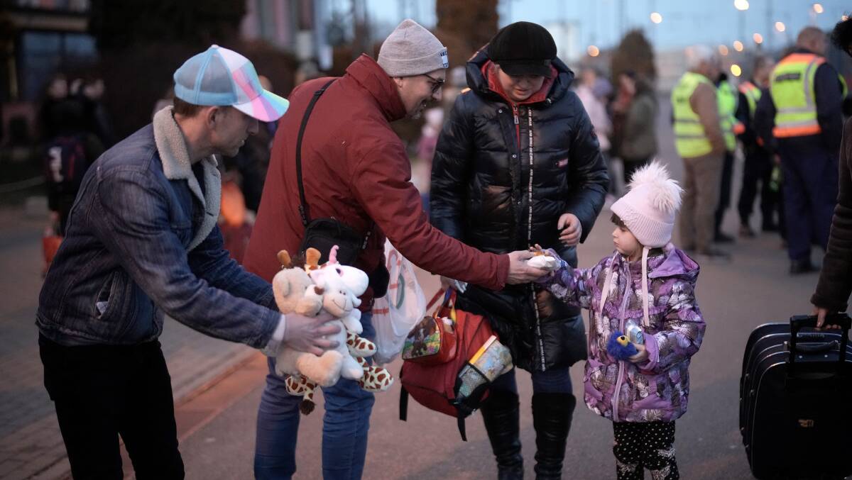 Volunteers from the United Kingdom give away soft toys to refugees fleeing Ukraine as they arrive in Hungary. Picture: Getty Images