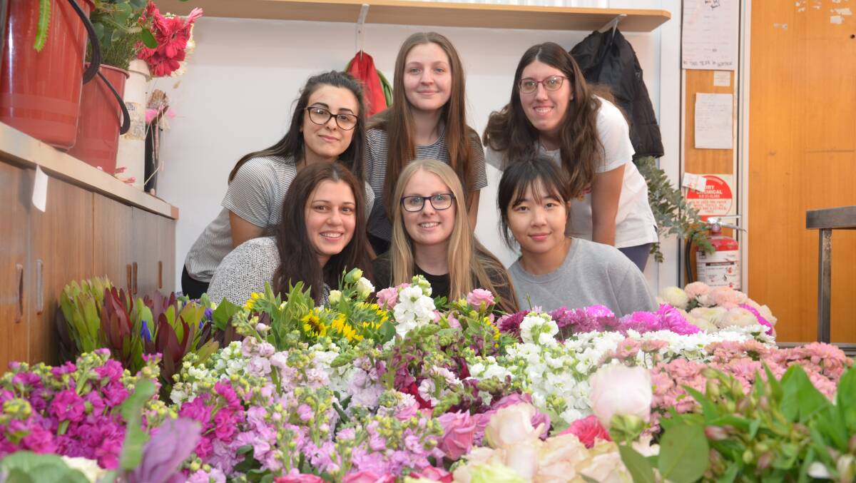 Blossoms Florist owner Cathy Catanzariti (front, left) with Talisa Ielasi (back, left), Marie Polimeni, Lydia Makepeace, Karli Forrester (centre, front) and May Kwon. PHOTO: Declan Rurenga