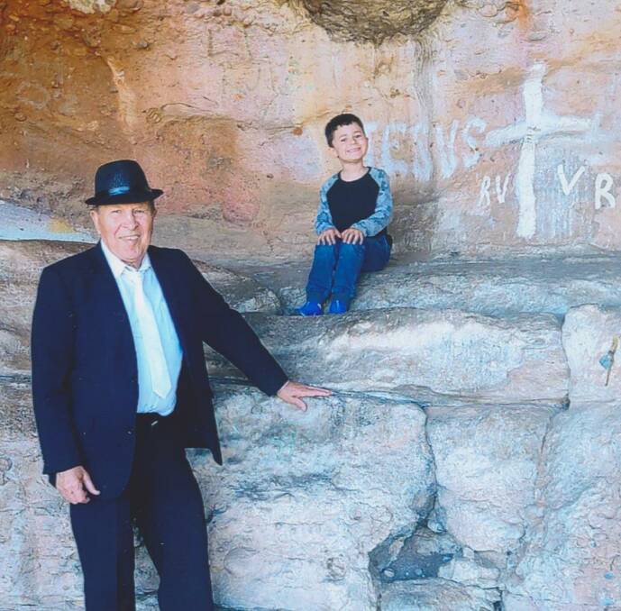 NEVER GIVEN UP: Mario Guerra with one of his grandsons, Kieran Corkery, at Hermits Cave on Scenic Hill. PHOTO: Supplied