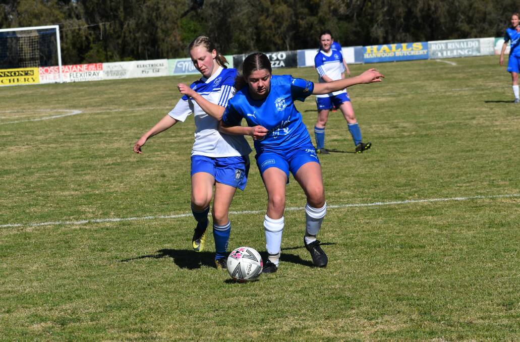 CONTESTED: Hanwood's Brianna Upcroft (left) duels with a Tolland Wolves player for possession in July. The Wolves could be one of the teams that Hanwood FC during their semi-final next week. PHOTO: Liam Warren