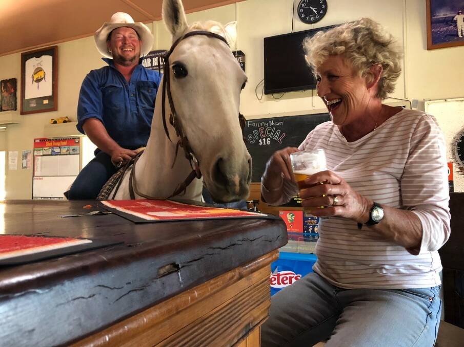 NEIGH BEER: Lance Anstice and Silver, have a beer with Back Roads presented Heather Ewart at the Black Stump Hotel in Merriwagga. PHOTO: Supplied