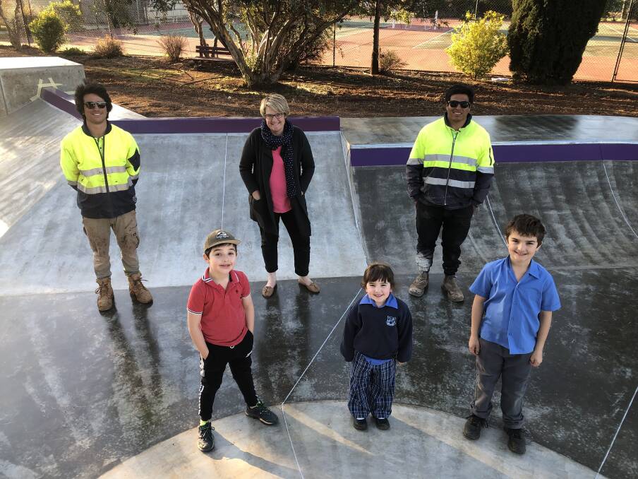 READY TO ROLL: Convic's Chris Herrera (back, left) and Carlos Membreno (back, right) are joined by Ann Furner (centre, back) and Robert, Emily and Michael Nehme for a quick tour around the completed park. PHOTO: Declan Rurenga