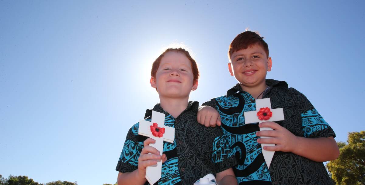 TRADITION: Nate and Mace Phillips helped place white crosses on the graves of our fallen ex-servicemen in 2019. PHOTO: Anthony Stipo