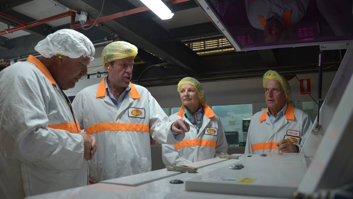 Trade minister Dan Tehan (second from left) and Sussan Ley tour the SunRice factory. PHOTO: Declan Rurenga