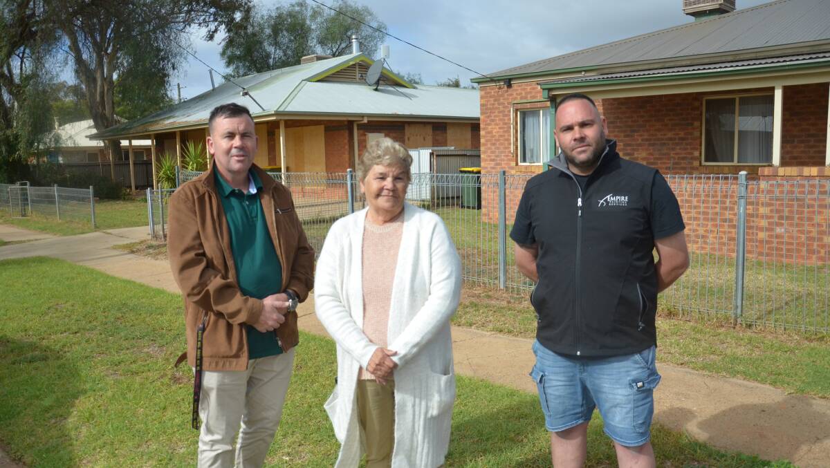 THE START: Griffith Local Aboriginal Land Council CEO Stephen Young, Aunty Patti Johnson and Empire Painting Services owner Rocco Romeo, with one of the two houses yet to see its roof repainted (left). PHOTO: Declan Rurenga