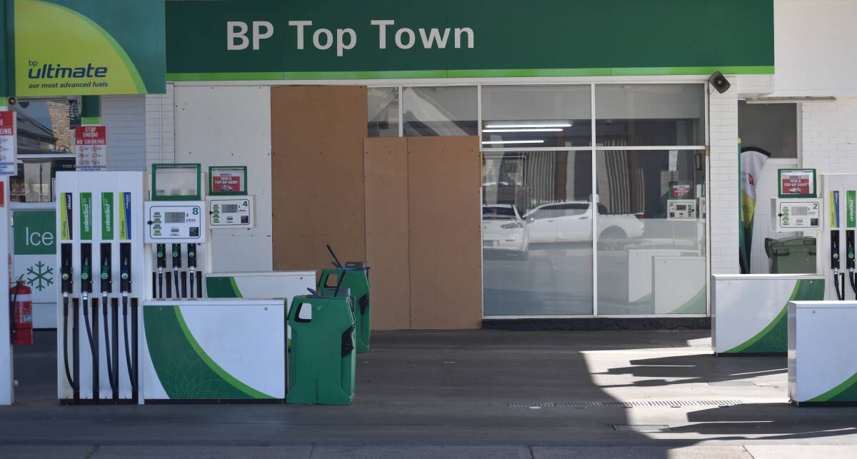 BOARDED UP: Two men have been charged over a ram raid at a Banna Avenue service station.