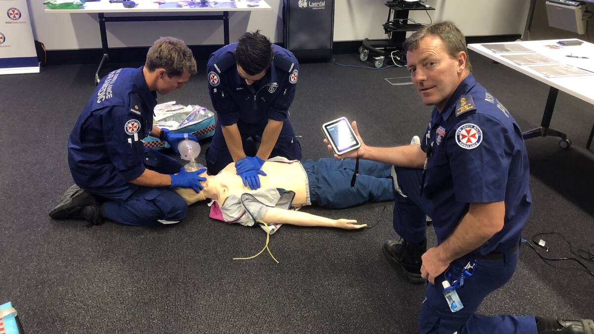 ALMOST REAL: Paramedic Huw Murray from Narrandera and Blake Pritchard from Coleambally practise their skills while paramedic educator Jeffrey Purse watches on his handheld screen. PHOTO: Declan Rurenga
