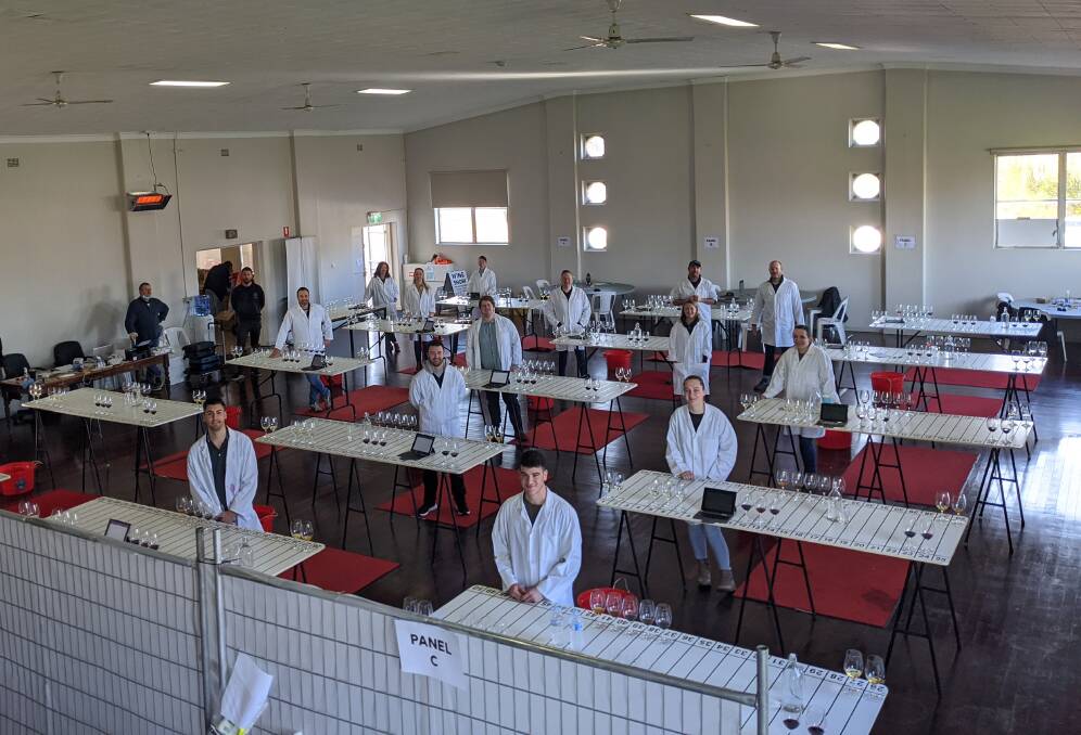 PLENTY OF SPACE: The Riverina Wine Show judging panel prepare to get on with the show. PHOTO: Contributed