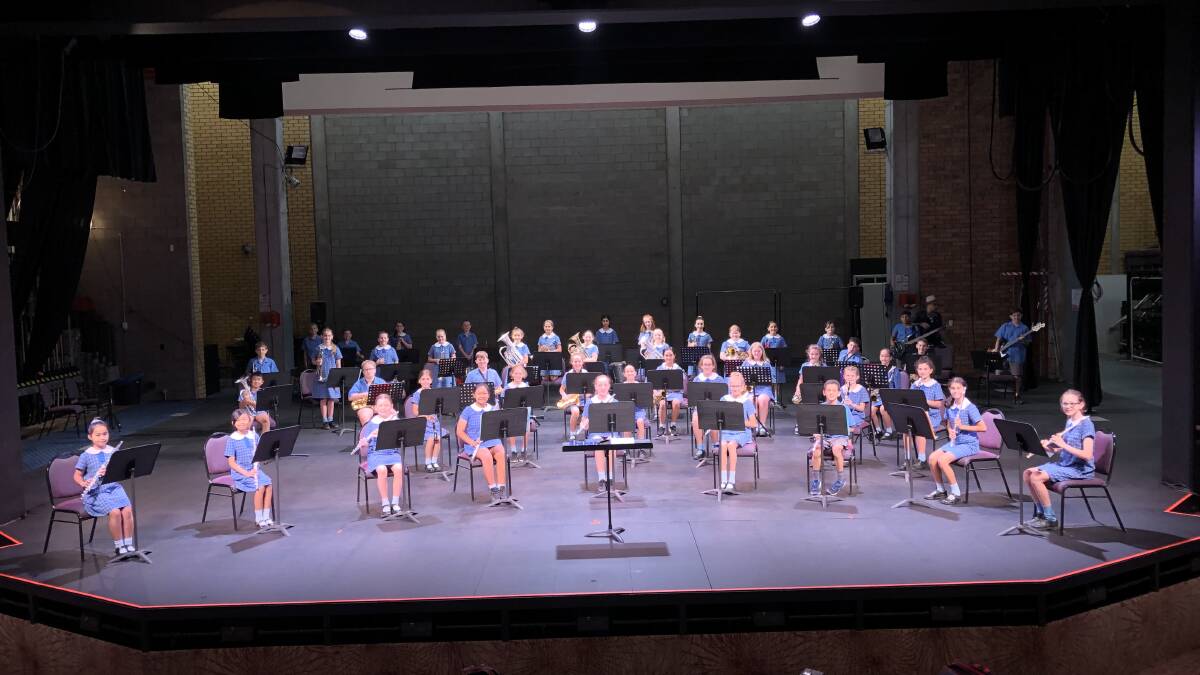 Griffith East Public School's band on stage at the Griffith Regional Theatre.