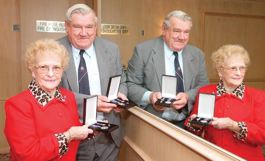 Irene Pettiford and Jim McGann with Commonwealth Centenary Medal they each received. PHOTO: The Area News archives.
