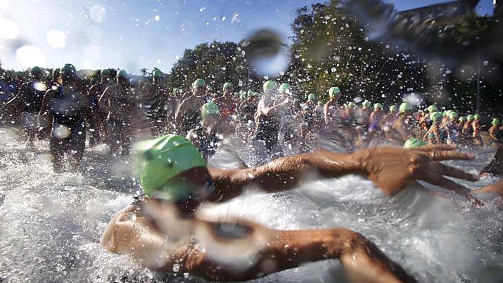 Wet and wild: Competitors make a splash in Sunday's swim. Photo: James Alcock