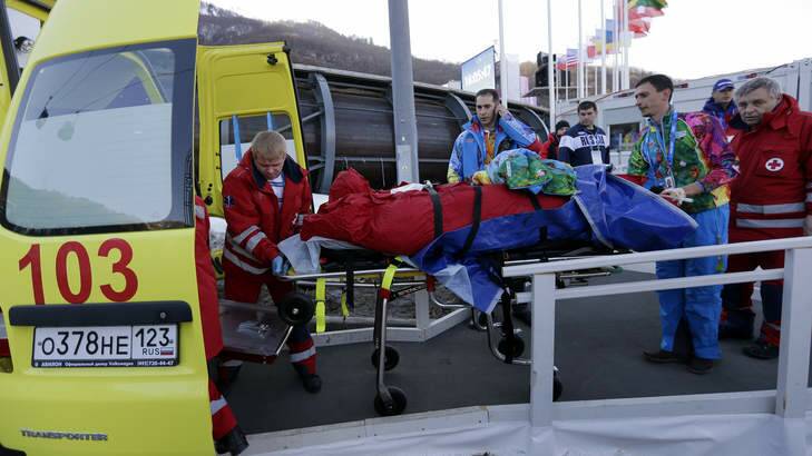 A track worker is loaded into an ambulance after he was injured when a forerunner bobsled hit him before the start of the men's two-man bobsled training on Thursday. Photo: AP Photo