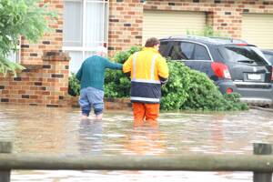 DEVASTATED: Yoogali residents are evacuated from Edon Street as floodwaters rise at the weekend.