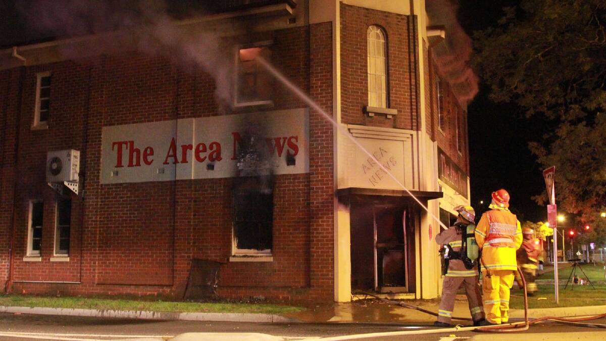Fire crews clamber to contain a second blaze which breaks out on the upper floor of The Area News building 45 minutes after the fire first broke out.