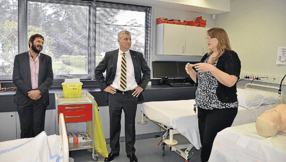 MEDICAL ADVICE: Wagga Rural Clinical School head Dr John Preddy and Riverina MP Michael McCormack gain advice on establishing a clinical school in Griffith from Coffs Harbour skills laboratory co-ordinator Jenine Griffiths.