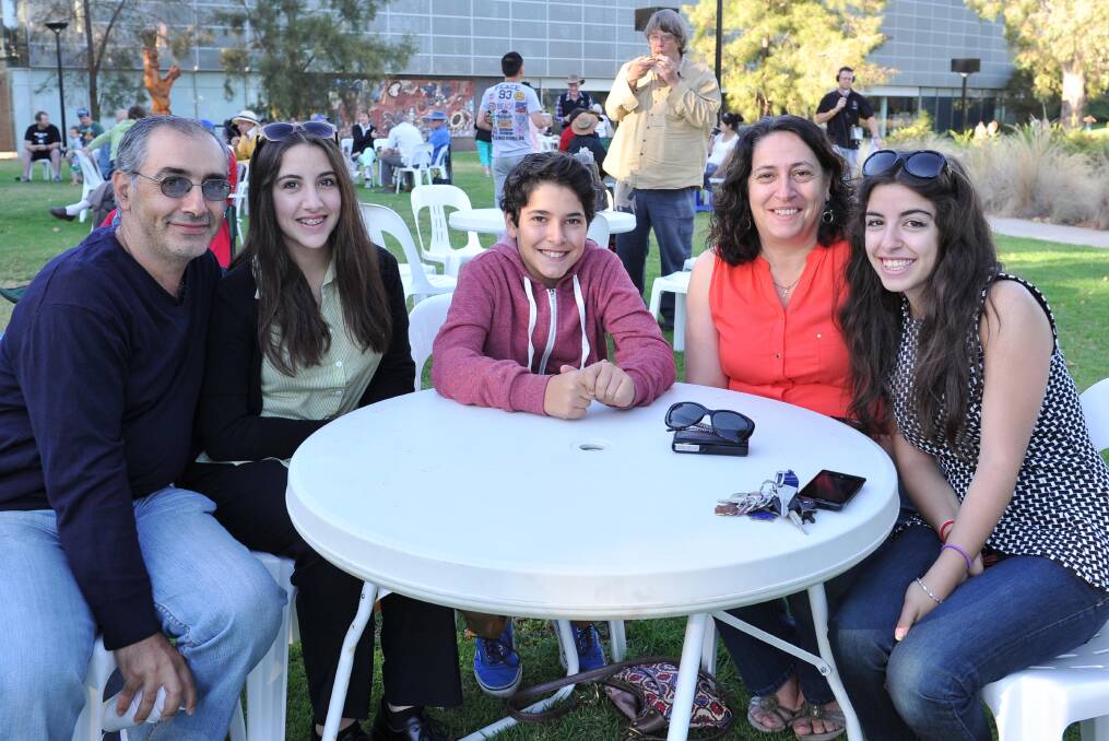 The Vecchio family of John, Sophie, 16, Andre, 13, Maria and Bianca, 18, enjoy their breakfast in the civic precinct at the Wagga Australia Day breakfast and citizenship ceremony. Picture: Michael Frogley