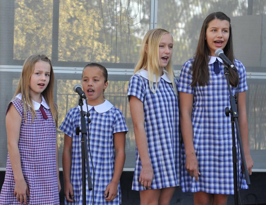 Performing the National Anthem are Jade Millard, 11, Alex Ingram, 10, Liberty Skeers, 11, and Sarah Jancewicz, 12, at the Wagga Australia Day breakfast and citizenship ceremony. Picture: Michael Frogley