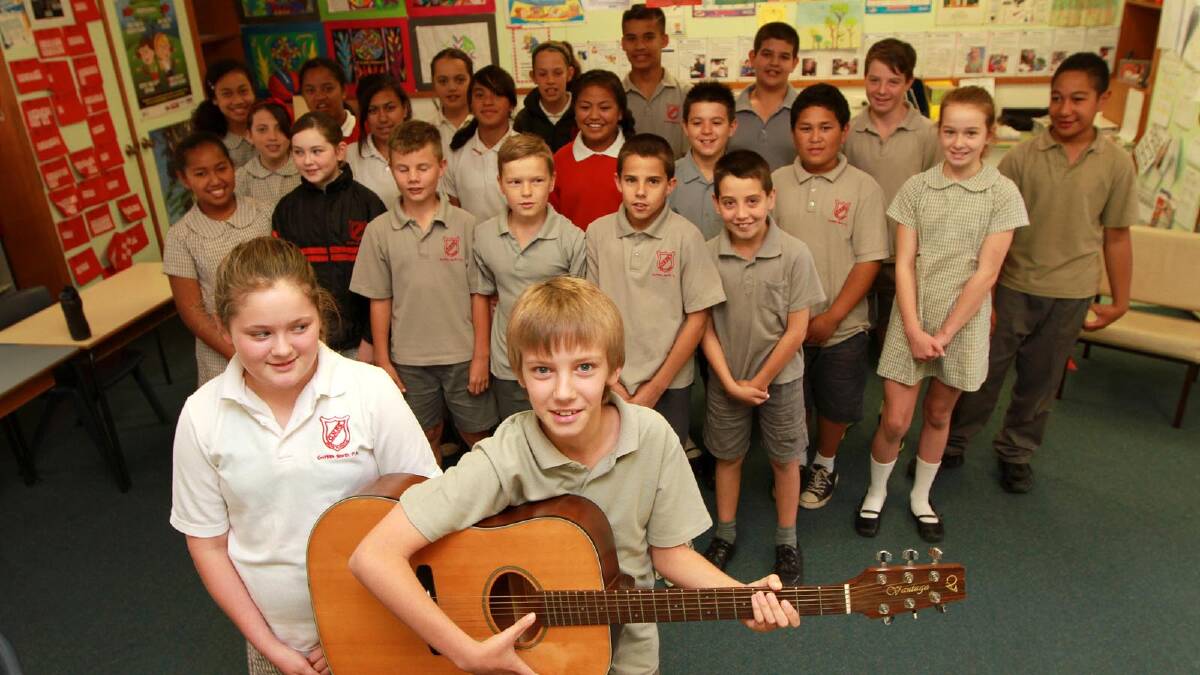 North Griffith Public School students Ella Frank, 11, and Jesse Knox, 11, along with classmates, practise for the upcoming Music Count Us In gig on Thursday. Picture: Anthony Stipo
