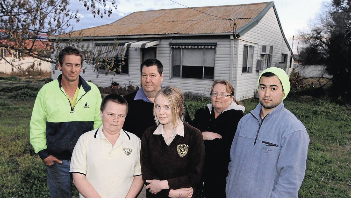 FED UP: Yenda flood victims Aleescha Croxon, 16, Brendon Croxon, 13, Maree Croxon, Stephen Croxon, Jason Dole and Ray Garofalo just want to move on from the March disaster, but are being held back by NRMA. Picture: Anthony Stipo