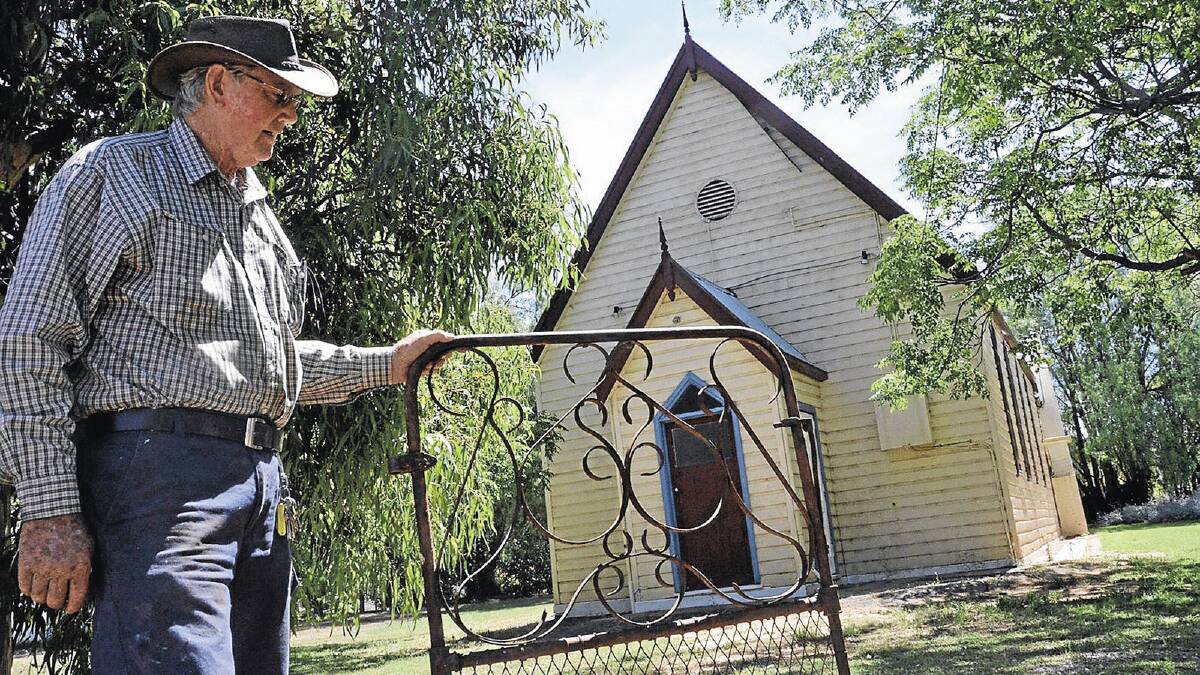 HEARTLESS: Bruce Gowrie-Smith holds the remains of the gates stolen from the Darlington Point Presbyterian Church last week.