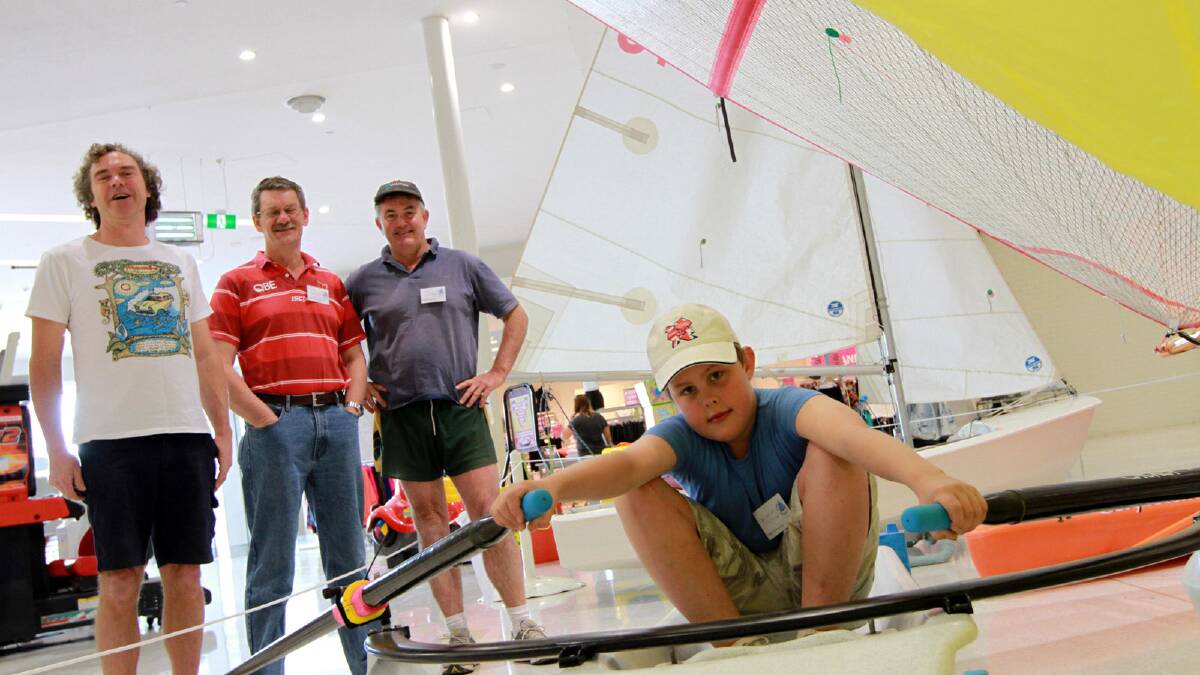 GIVE IT A GO: Matthew Hutchinson, 10, tries his hand in the Griffith Sailing Club's training skull while (from left) Dirk Hoogland, Tom MacKerras and Paul Hutchinson watch on. The club erected a special display at Griffith Central this past weekend in preparation for their come and try weekend at Lake Wyangan on Saturday and Sunday.