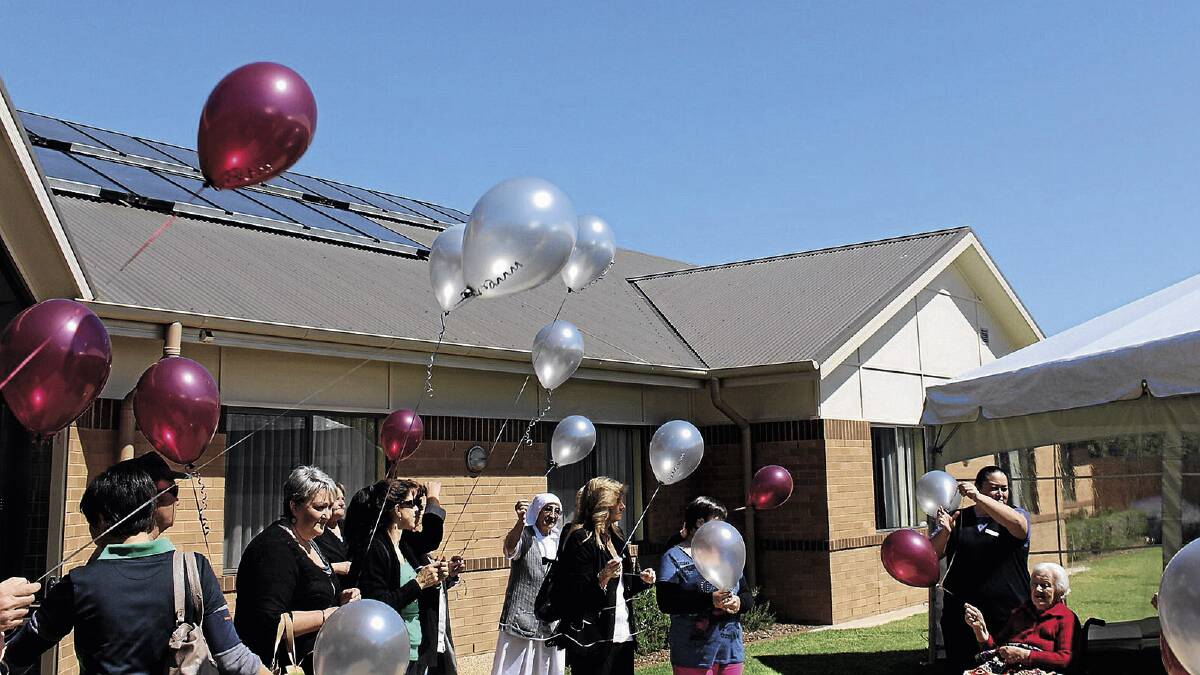 Scalabrini residents release balloons at the funeral.