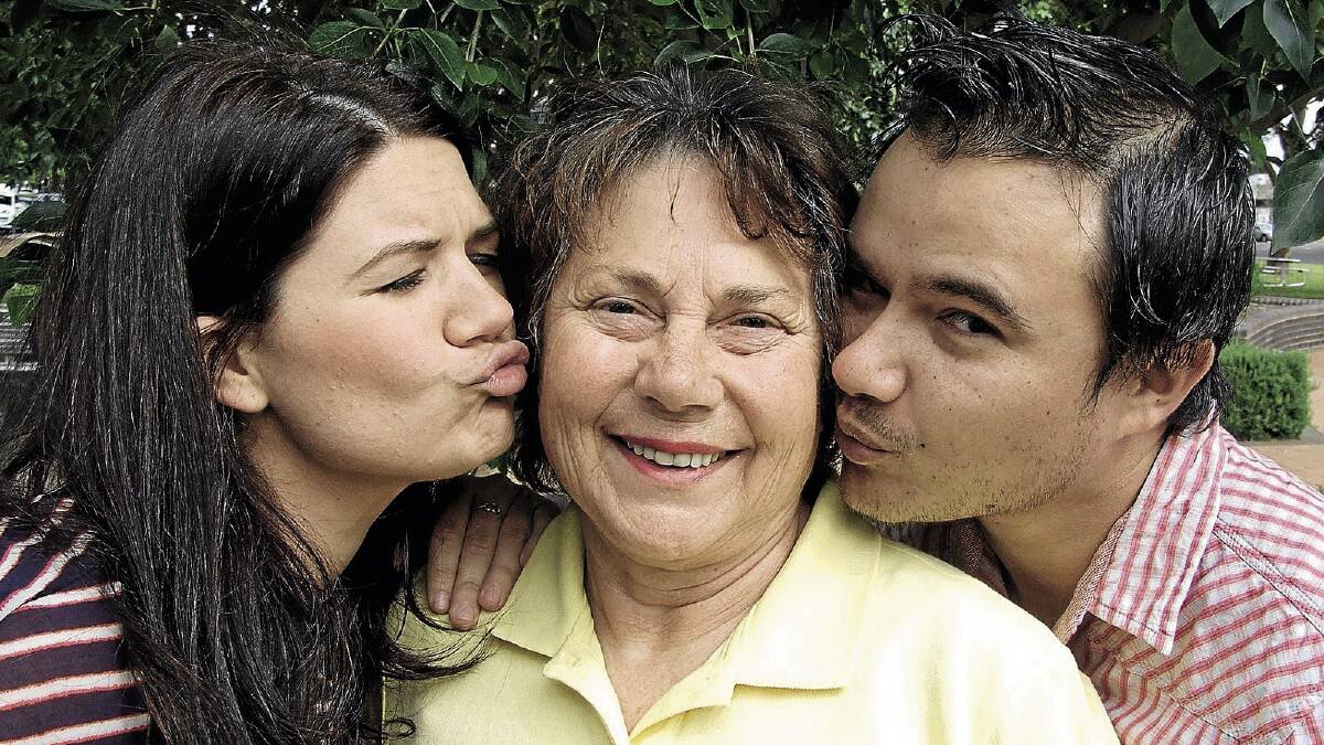 PUCKER UP: Star FM breakfast co-announcers Tanya Hennessy (left) and Mike Narrier (right) practice their smooching on Can Assist Griffith president Olga Forner ahead of the big pash for cash.