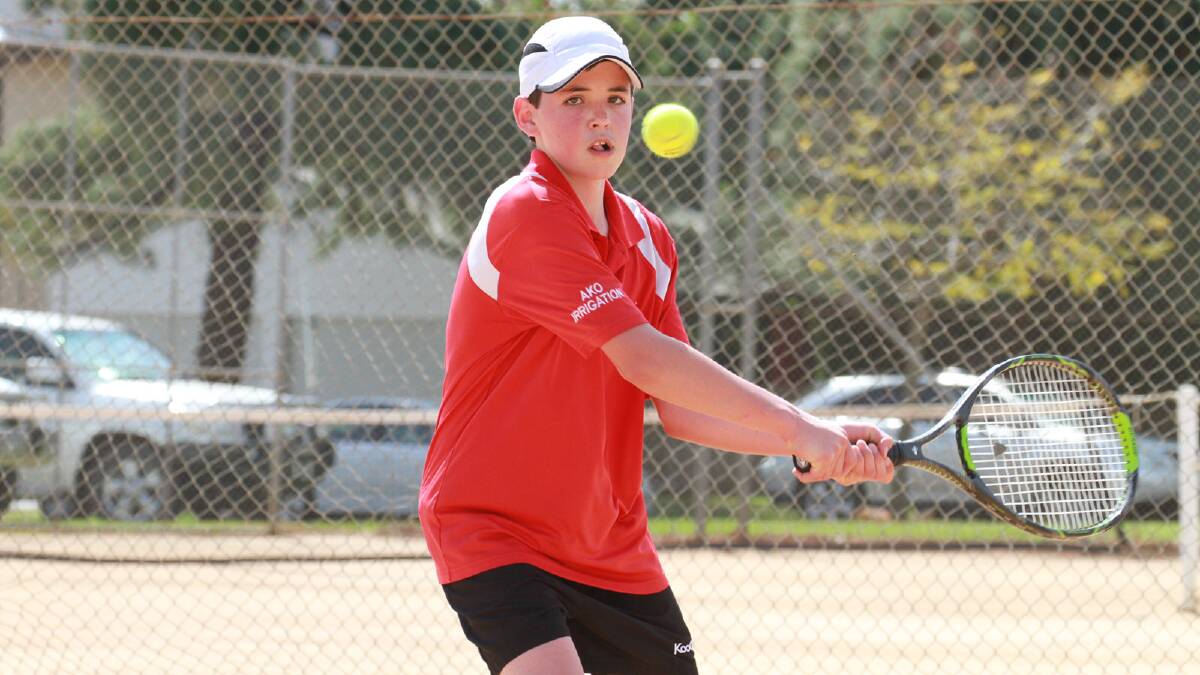 SMASH HIT: Wilkus van Tonder winds up this backhand shot on the opening day of the first ever Optus Junior Tennis Tournament in Griffith on Monday. 	Picture: Anthony Stipo