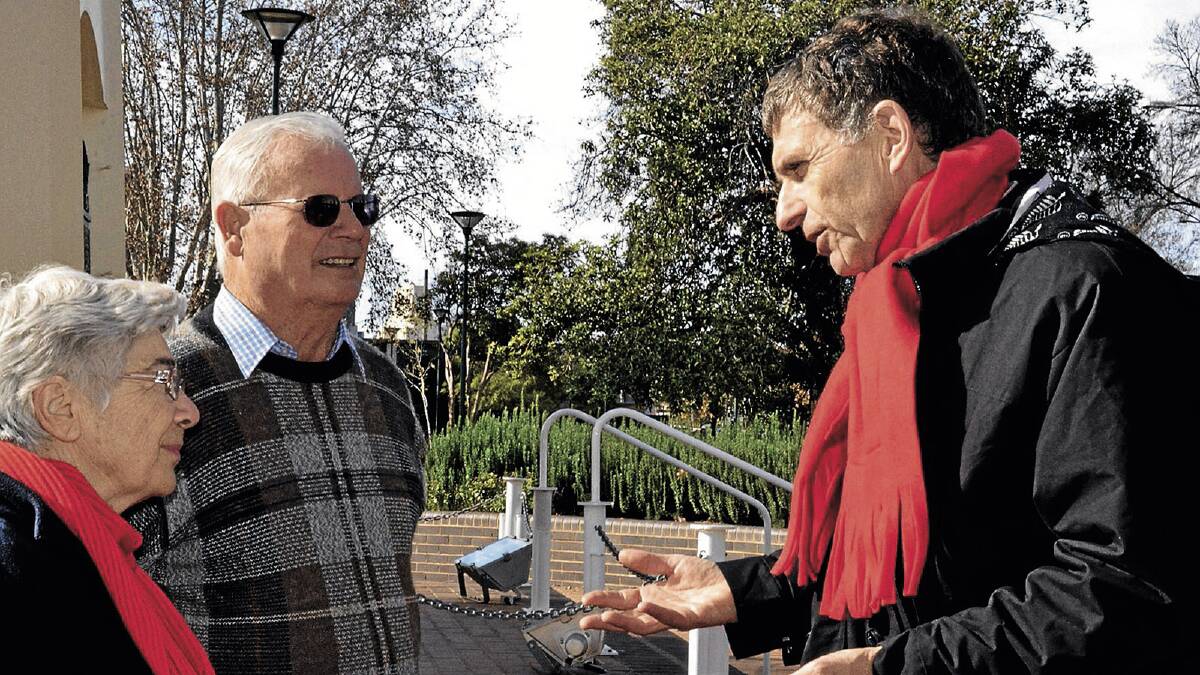 POWERFUL: One Big Switch director Christopher Zinn (right) talks to Griffith couple Ada and Aldo Zanesco about their electricity bill in Memorial Park yesterday.