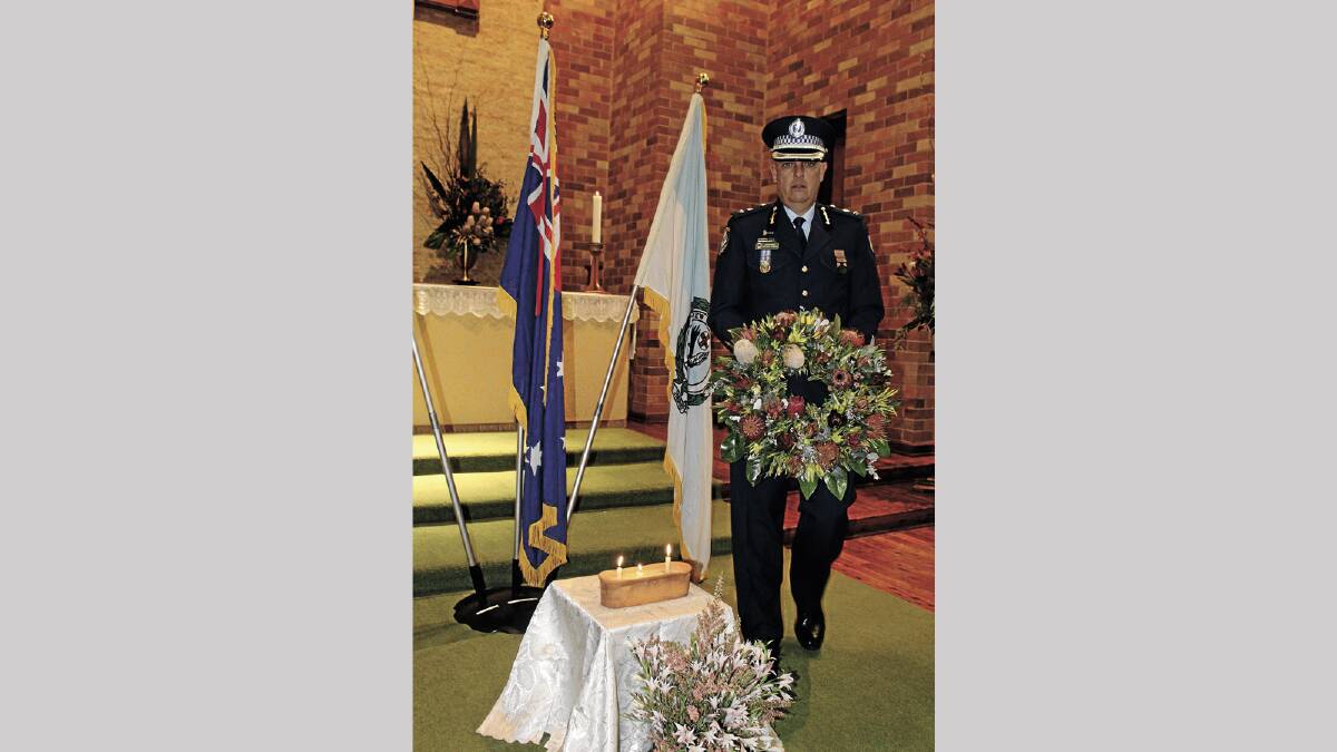 IN MEMORY: Griffith Police Superintendent Michael Rowan places a wreath in St Albans Cathedral on Friday for Police Remembrance Day.