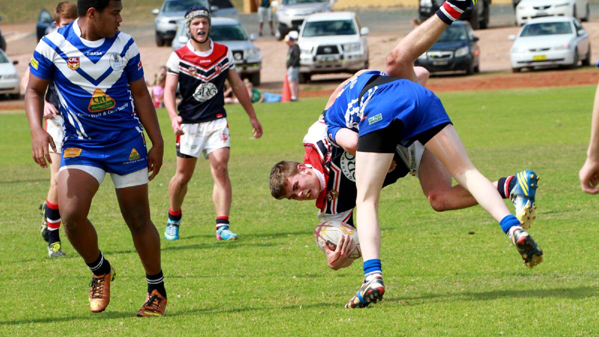 DPC's Brad Lyons is tackled in the Group 20 under 16s grand final against Yenda. Picture: Anthony Stipo