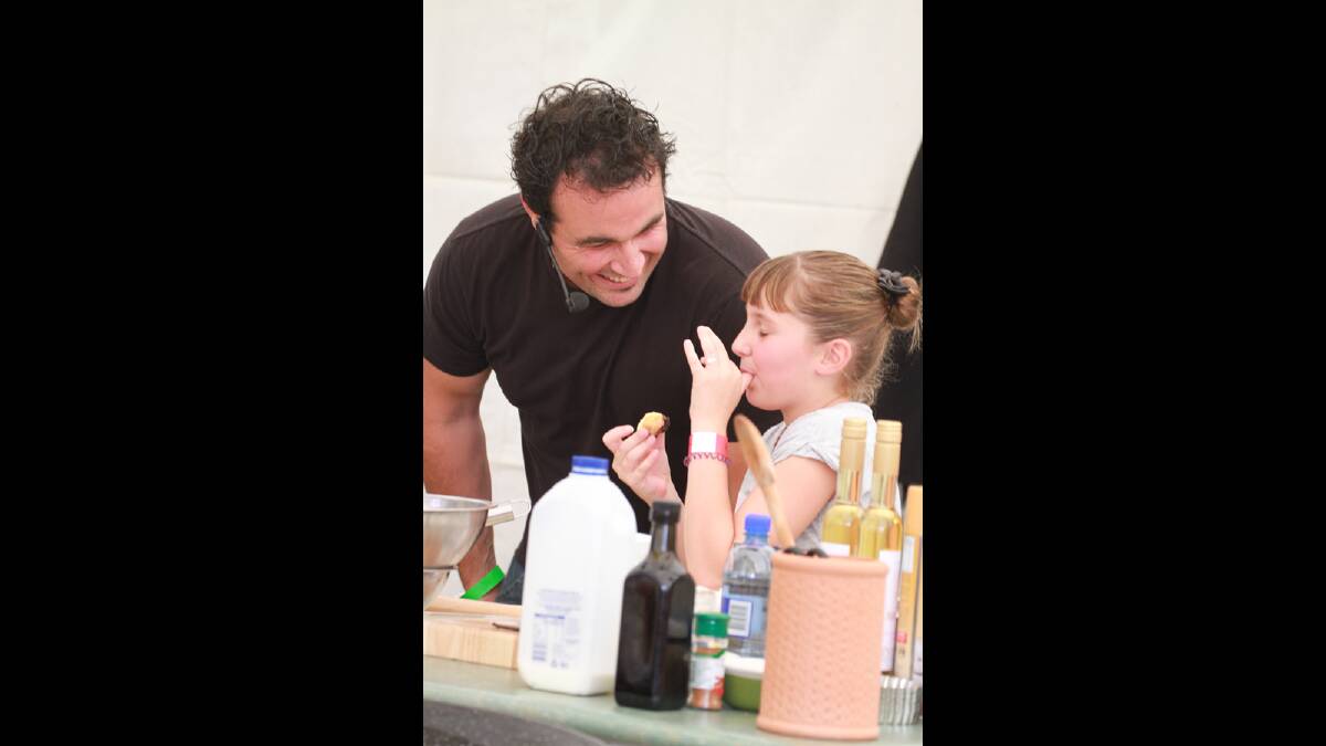 Celebrity chef Migueal Mastre chates to Forja Heffer, 10, at La Festa on Easter Saturday.  Picture: Anthony Stipo